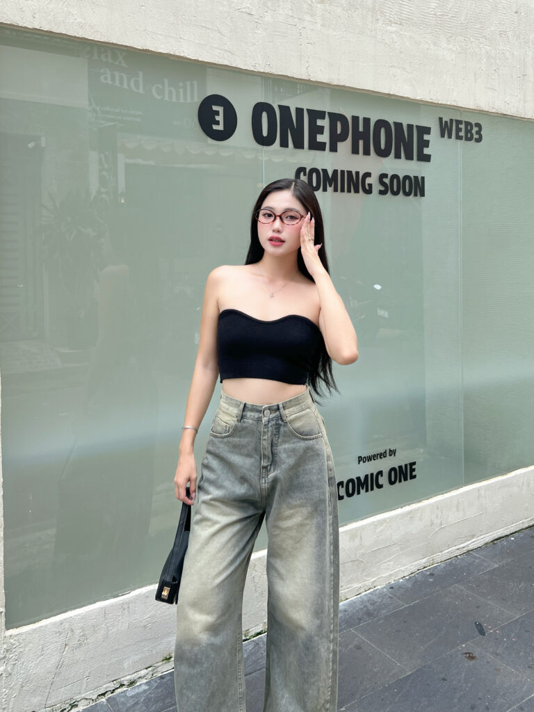 K-pop idols in wide-leg jeans set against an urban backdrop, embodying the trend.